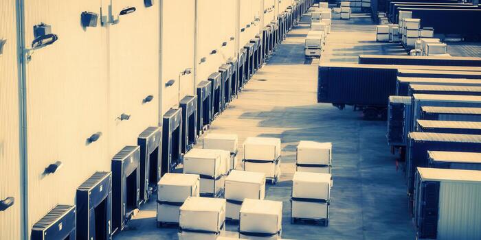 Busy loading dock filled with trucks and containers ready for transport and distribution. photo