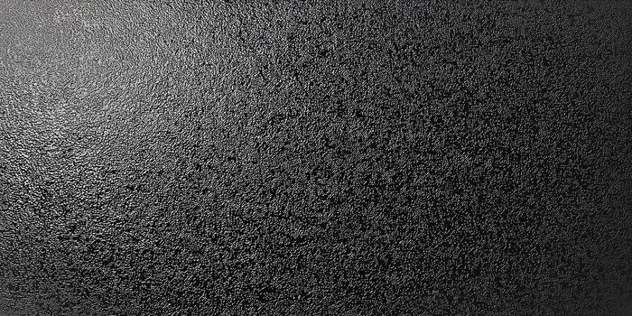 A detailed close-up of a textured black surface with a rough, grainy pattern. photo