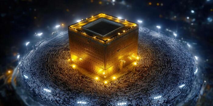 Aerial view of the illuminated Kaaba, surrounded by worshippers during Hajj pilgrimage at night. photo