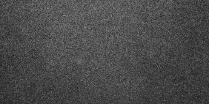 Detailed view of a textured, grainy dark grey background. photo
