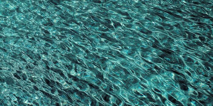 Captivating view of rippling turquoise water, creating a mesmerizing pattern of light and shadow. photo