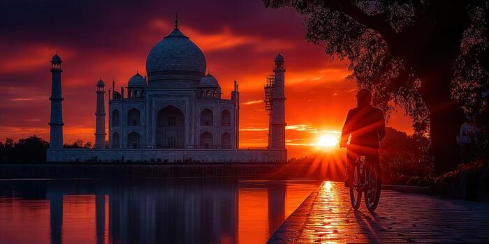 Sunset view of the Taj Mahal with a person cycling towards the sun. photo