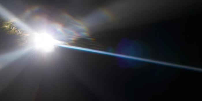 Vibrant light rays burst from a bright, intense source, creating a stunning abstract display. photo