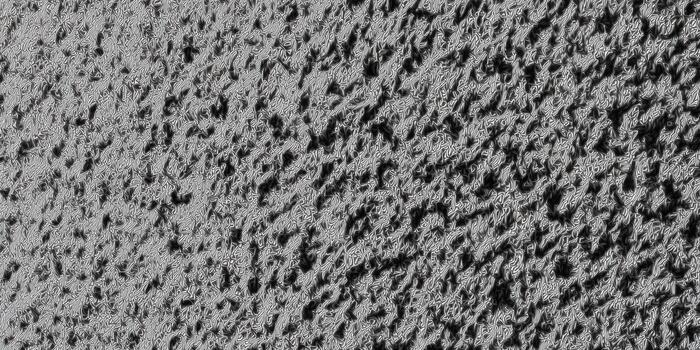 A detailed close-up of a textured surface reveals a dynamic play of light and shadow. photo