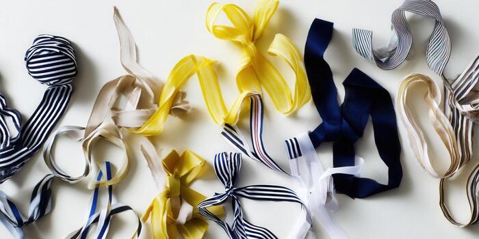 Colorful ribbons in different patterns and shades create a textured and visually appealing display on a white surface. photo