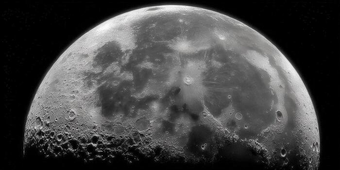 A captivating view of the moon revealing its textured surface with prominent craters against a black background. photo