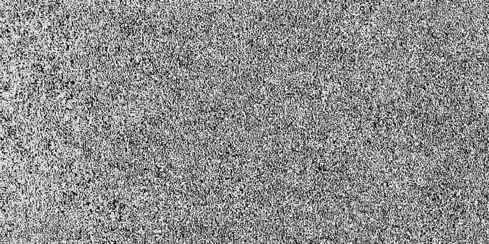 A monochrome abstract texture with a granular, grainy pattern in black and white. photo