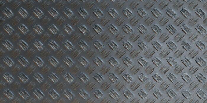 Close-up of a textured, diamond plate pattern, perfect for industrial designs and backgrounds. photo