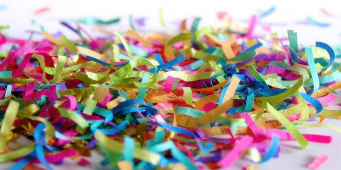 Vibrant confetti scattered on a white surface, creating a joyful and colorful scene. photo