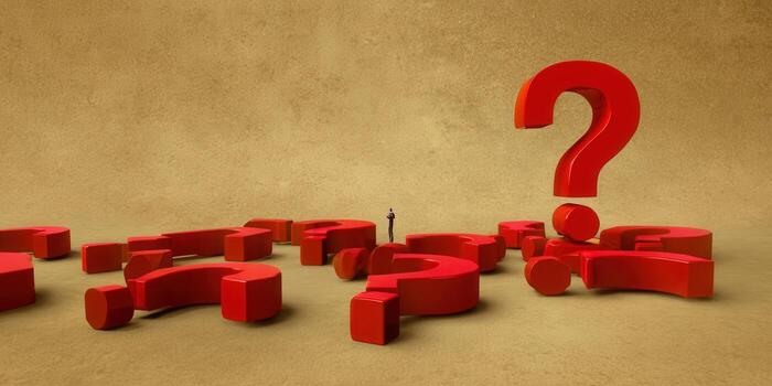 A tiny person looks at big red question marks, representing queries and doubts photo