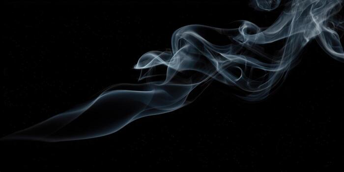 Elegant wisps of white smoke gracefully swirling against a deep black backdrop, creating an abstract visual photo