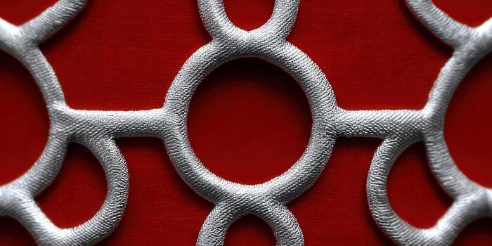 A striking silver geometric pattern against a deep red background, full of detail. photo