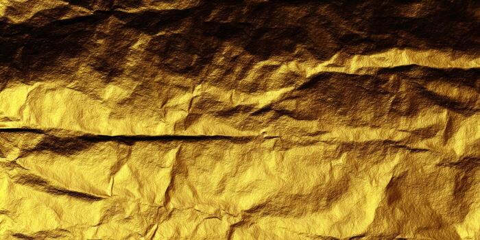 Detailed view of a textured, golden surface, showcasing the interplay of light and shadow across its intricate patterns. photo