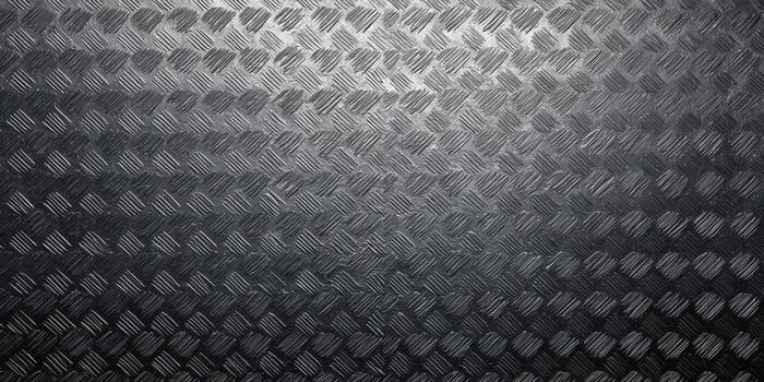 Diamond plate metal texture in a dark, industrial style with a subtle gradient effect. photo