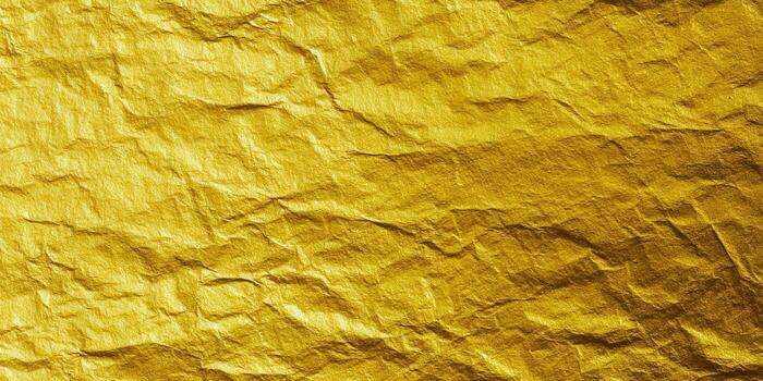 Detailed golden foil texture with crinkled surface and textured pattern. photo