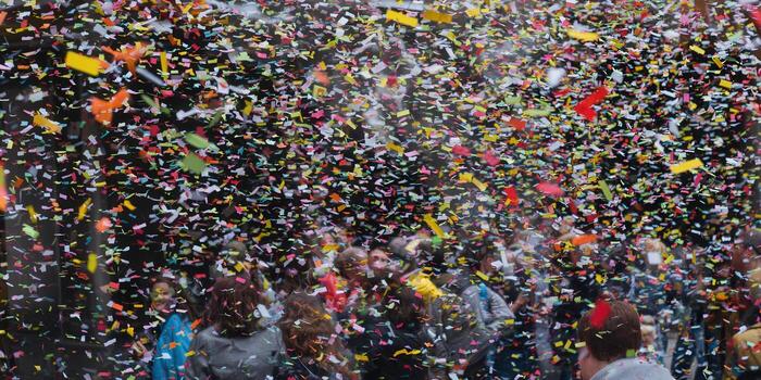 Confetti fills the air above a crowd, creating a lively and celebratory scene. photo
