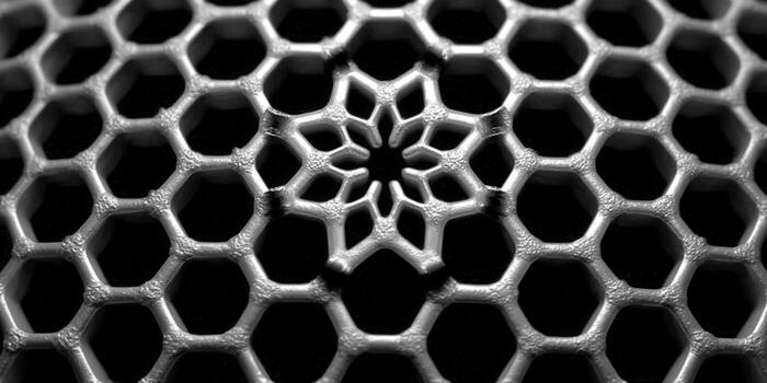 Intricate hexagonal structure in metallic detail against a dark background. photo