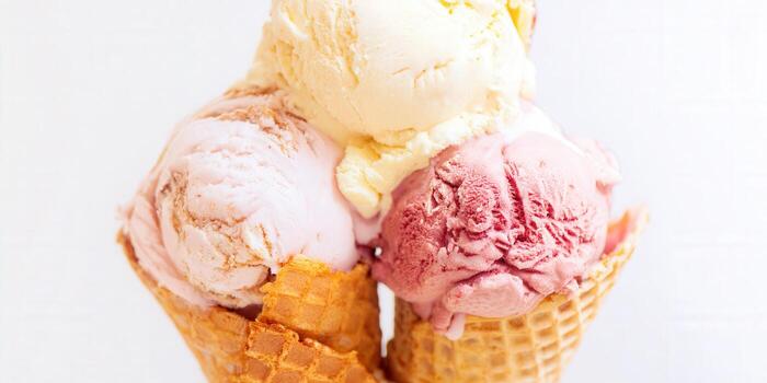 A close-up shot of multiple ice cream scoops in waffle cones. photo