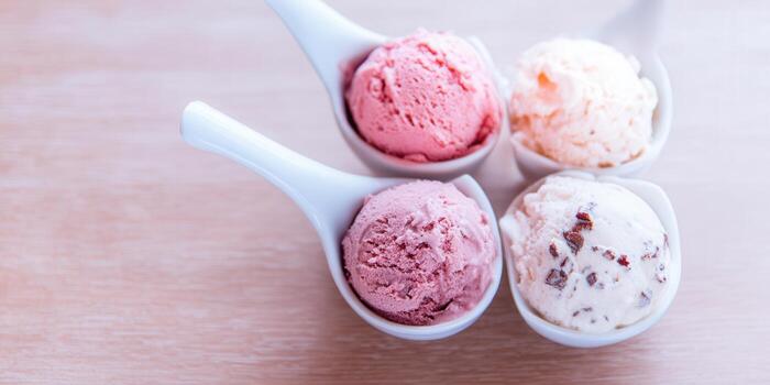 Close-up shot of assorted ice cream scoops on white spoons, a sweet treat. photo