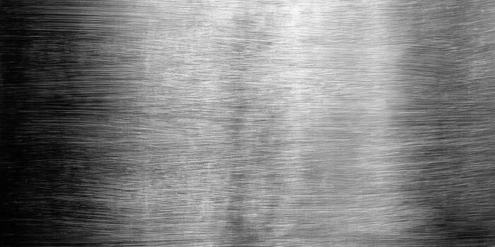 A close-up of a brushed metal surface with a gradient effect, perfect for backgrounds. photo