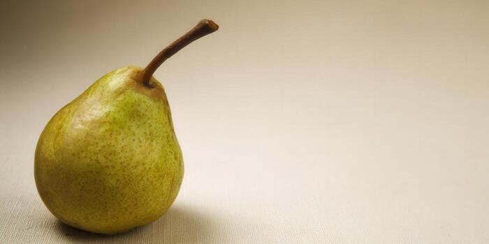 A fresh, ripe pear isolated on a simple background, perfect for various uses. photo