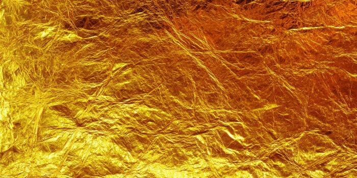 Close-up of a gold metallic background with a textured, shiny surface. photo