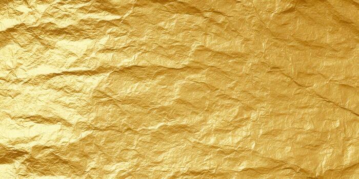 Close-up of gold foil texture, creating a rich, luxurious background with shiny details. photo