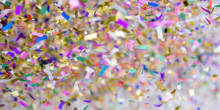 A vibrant image of colorful confetti falling down creating a joyful celebratory scene. photo