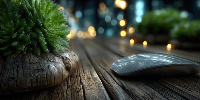 A modern wireless computer mouse on a textured wooden table with a succulent plant. photo