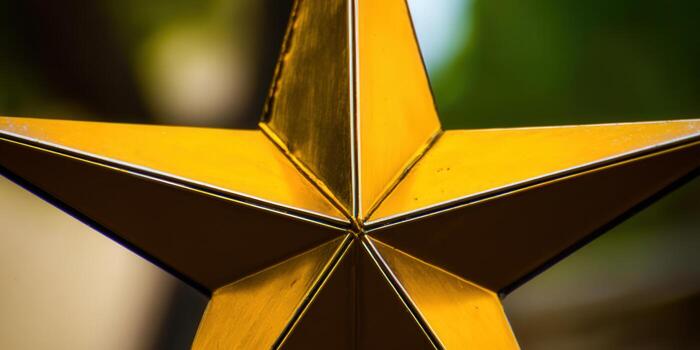 A close-up shot showcasing a beautiful golden star with intricate details and sharp edges. photo