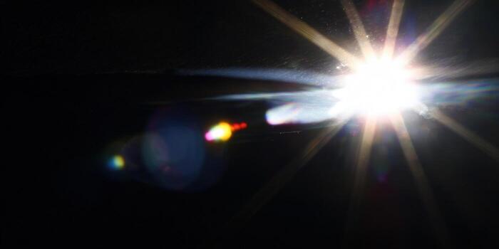 Bright light bursts forth in a dramatic display of energy with striking contrast against the darkness. photo