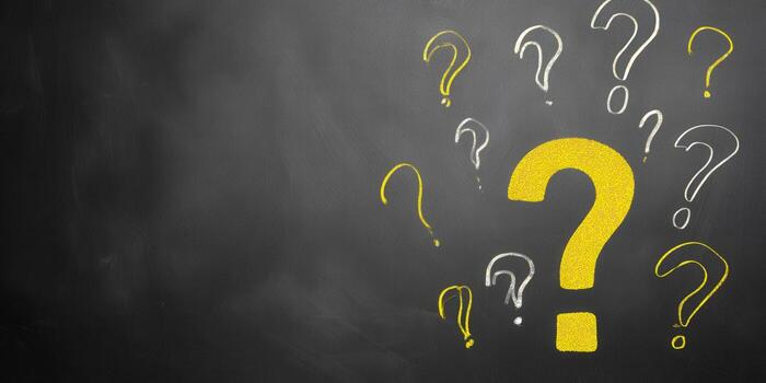 Many question marks on a dark chalkboard, perfect for educational concepts. photo