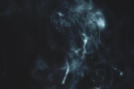Ethereal Smoke Swirls on Dark Background Creating a Mysterious and Atmospheric Abstract Visual Effect photo