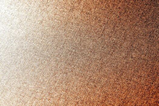 Close-Up of Textured Brown Fabric with Intricate Weave Pattern and Warm Lighting for Background or Design Use photo
