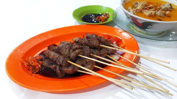 Sate Kambing with Gulai Soup and Soy Sauce. Indonesian food. Isolated on White Background photo