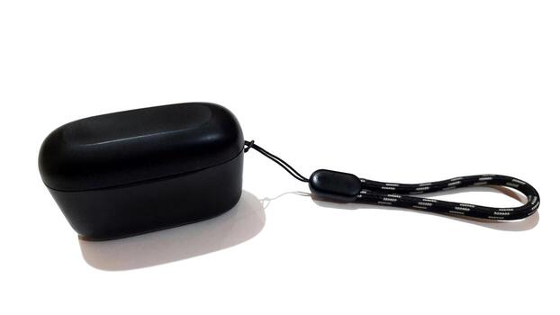 Black wireless bluetooth in ear headphones with charging case isolated on white background photo