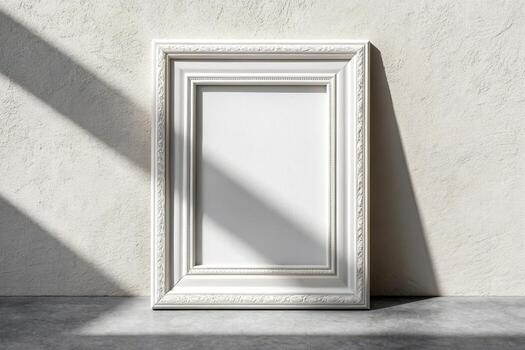 Ornate white picture frame leaning against a textured wall with shadow play photo