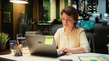 Engaged general manager researching market data and designing strategies to meet business goals, using spreadsheets for proofreading. Late night work in a multinational company. Camera A. video