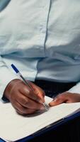 Vertical Close up of candidate filling in registration forms for job application and interview, ensuring a great recruitment process and successful meeting with the HR. Writes down qualifications. Camera A. video