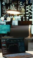 vertikal professionell arbetstagare i kontor monitorer stock trender och ljusstake diagram på bärbar dator, använder sig av data analys, prognostisering och finansiera strategi till optimera handel och uppnå inkomst mål. kamera a. video