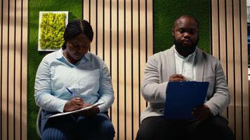 Close up of candidates filling in registration forms for job application and interview, ensuring a great recruitment process and successful meeting with the HR. Write down qualifications. Camera A. video