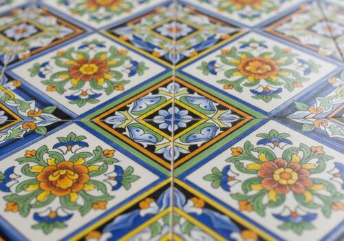 A close up of a colorful tile with flowers photo