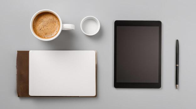 Desk with coffee, notebook, and tablet in minimalist design photo