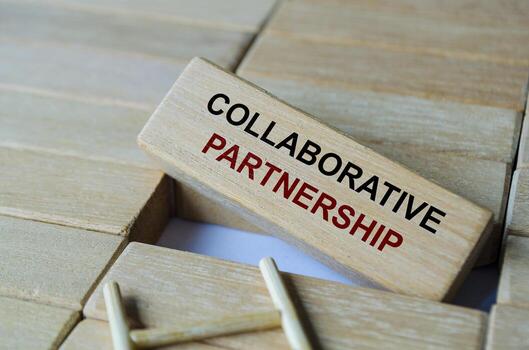 Collaborative Partnership text written on wooden blocks arranged on a ladder emphasizing teamwork and shared effort. photo