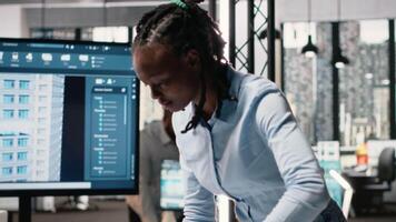 Real estate staff member evaluating architectural measurements on blueprints and 3D models for the construction project. Developer with a new residential project for the future. Camera B. video