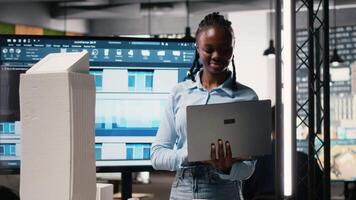 African american developer using modern design software to create a vision for a urban infrastructure, focusing on property construction and residential area planning. Innovation hub. Camera B. video