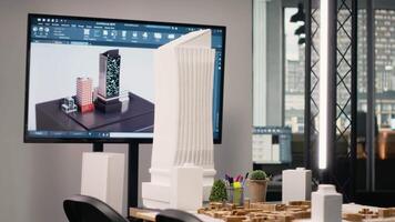 Business office used for property investment planning and project discussions, showcasing empty furniture setup, blueprints and 3D design models for housing and urban redevelopment. video