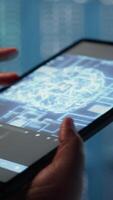 Vertical Data center technician using machine learning on tablet to optimize operations. IT specialist using device in server room with specialized gear accelerating complex AI calculations, camera B video
