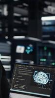Vertical Programmer doing data center automation using AI software tools, enhancing workflow. Server room IT expert implements artificial intelligence driven predictive maintenance systems, camera B video