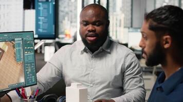 Engineer and designer working together on real estate interior design, using software for professional layout and structure. Creating master plans and reviewing construction blueprints. Camera B. video